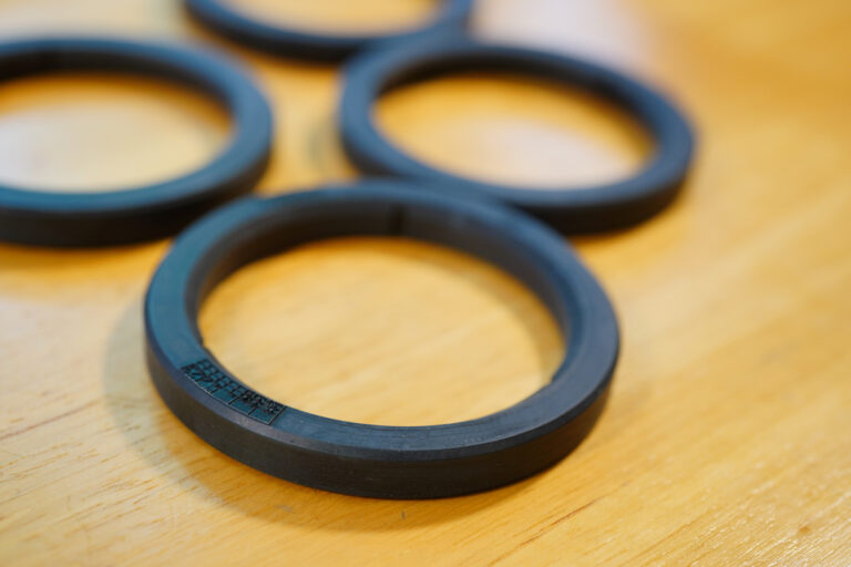 Black custom O-rings designed for industrial sealing applications and leak prevention.